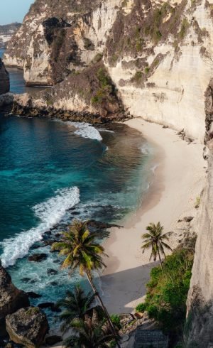 ocean-hitting-sandy-beach-surrounded-by-cliffs